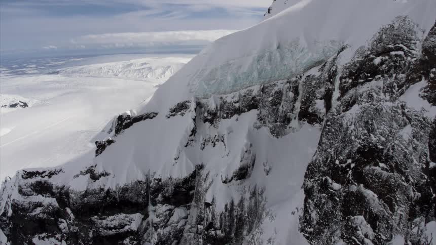 A mountain range covered in snow and ice during the winter