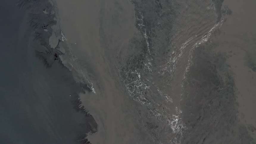 An aerial view of the ocean is displayed