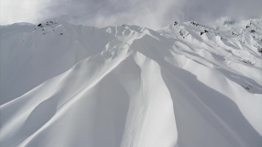 A vast mountain range is covered in deep snow