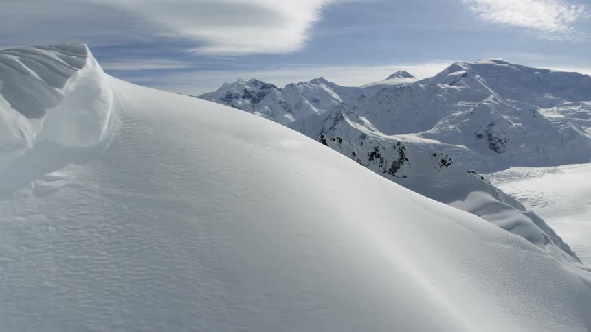 Sunlight starts to melt snow on a mountain range