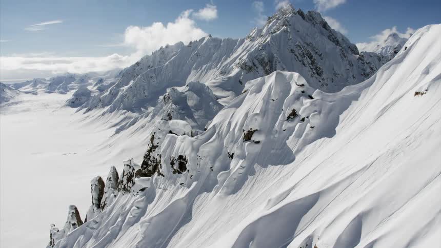 A mountain range covered in snow in the winter