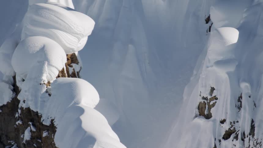 A snow covered mountain rises high into the sky