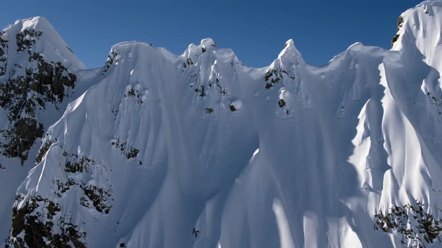 Tall snow covered rugged mountain range