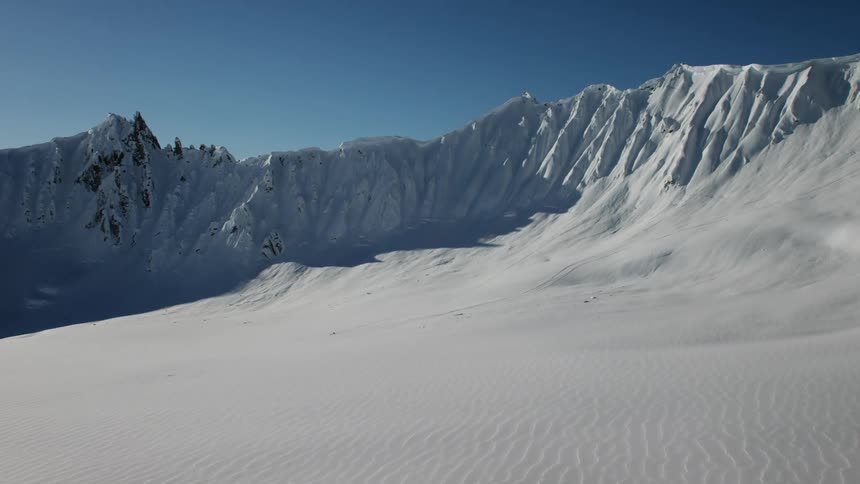 The snow sits atop the mountains