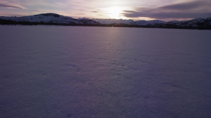 Snow in front of a mountain range