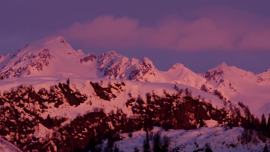 A mountain range covered in snow in the winter