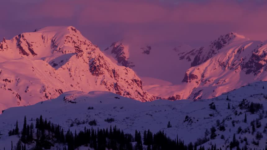 A mountain range covered in snow during the winter