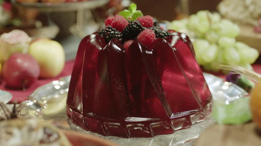 Jello dessert with berries on top displayed on a table