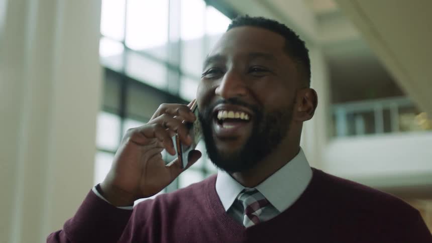 The man answers his phone