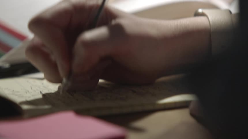 A woman writing on paper