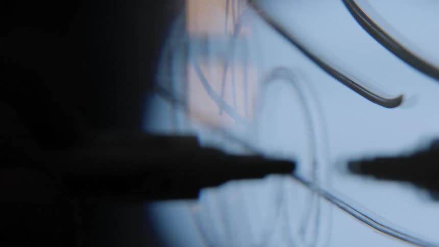 A persons hand writing on a reflective surface with a marker