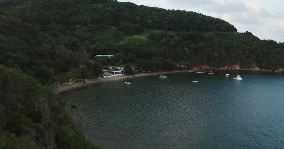Aerial view of a small resort on a tropical coast next to the ocean