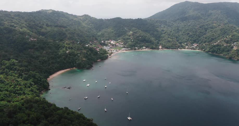 Aerial view of tropical island cove with sailboats