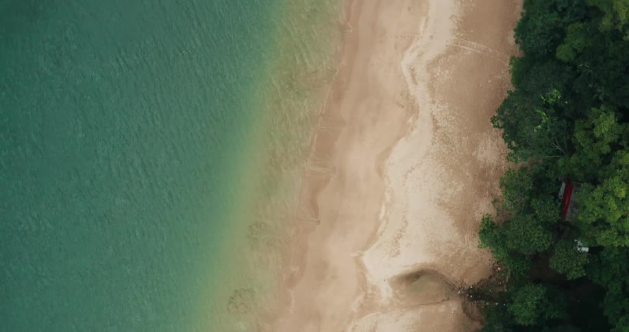 Aerial view of waves on island beach