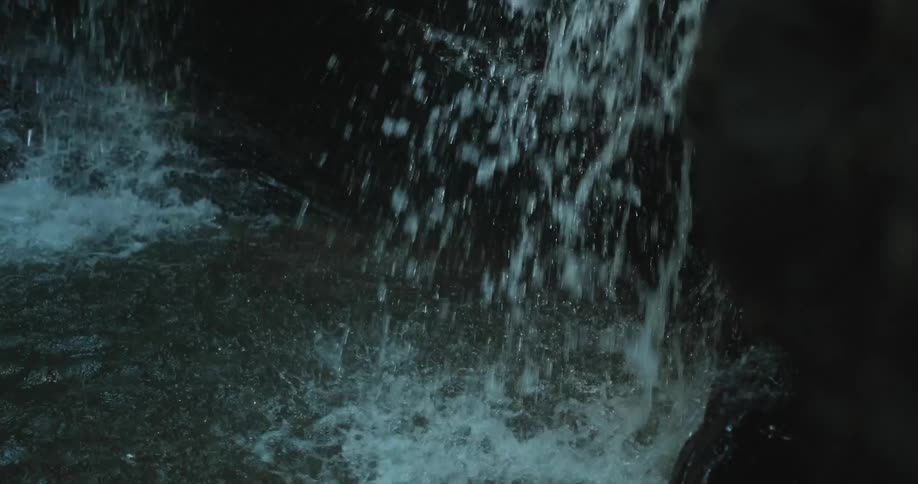 A waterfall courses over rocks into a pool