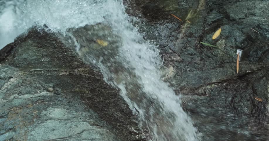 The water shoots off the top of the waterfall