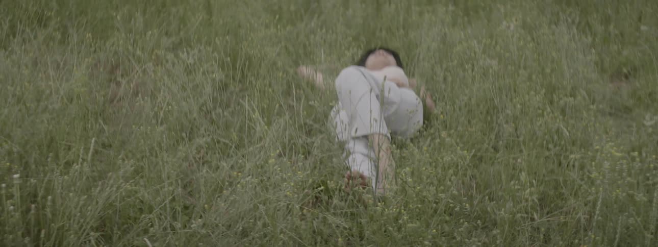 Woman lies down on the grass