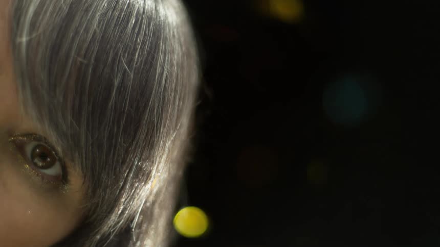 A woman with glitter falling behind and in front of her