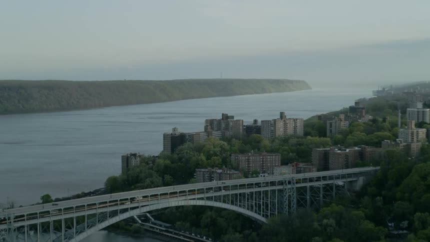 A bridge and city center sits near to a large river