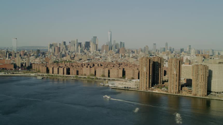 A city skyline is displayed by an ocean