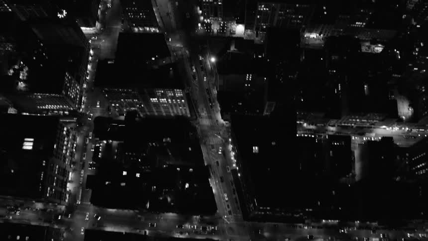 Cars move on roads that bisect tower blocks in a downtown area