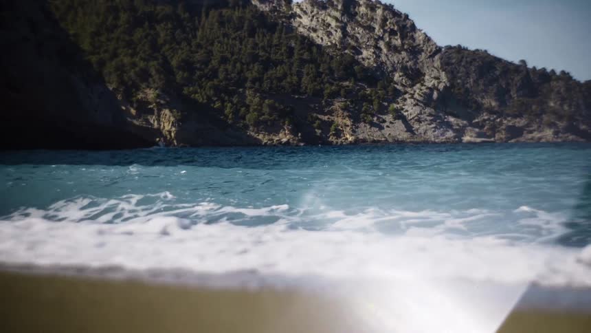 Small waves crash against the beach