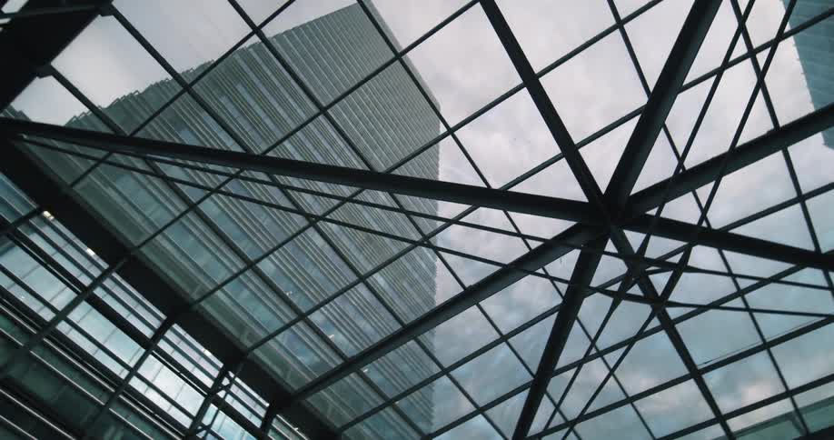 Worms eye view looking through windows up at skyscrapers