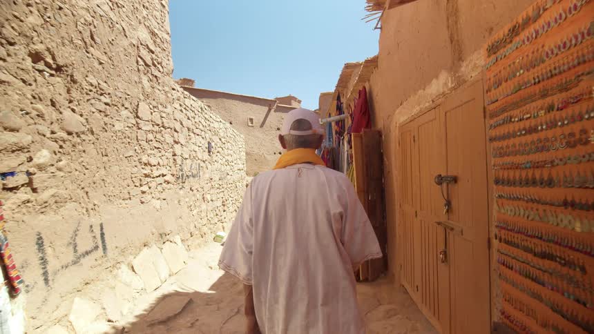A man is walking down the alley