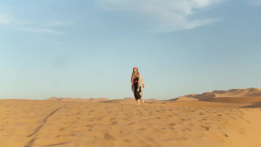Woman walks in the desert
