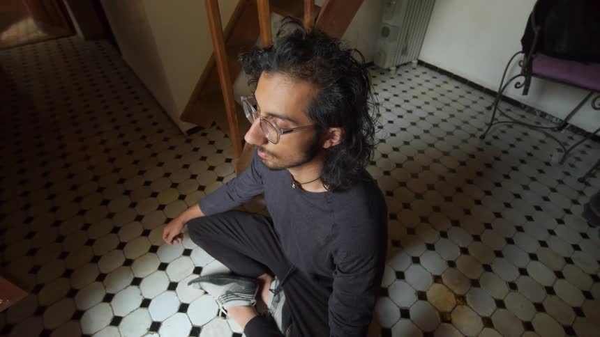 A man is sitting in a room