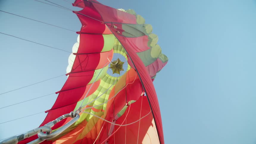 A colorful canopy is attached to a carnival ride