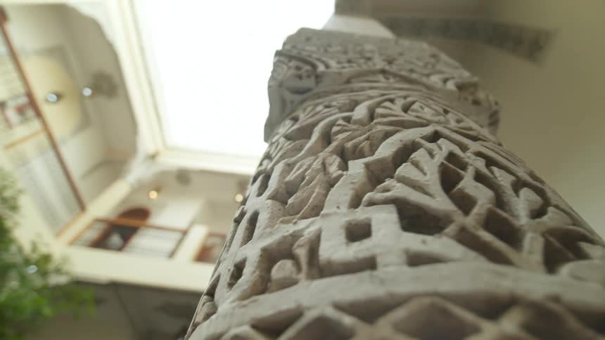 The pillar on this apartment building has carvings all around