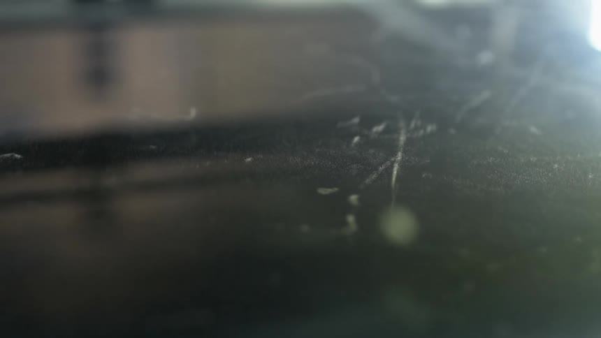 Light shimmers and glows on threads and particles on a surface