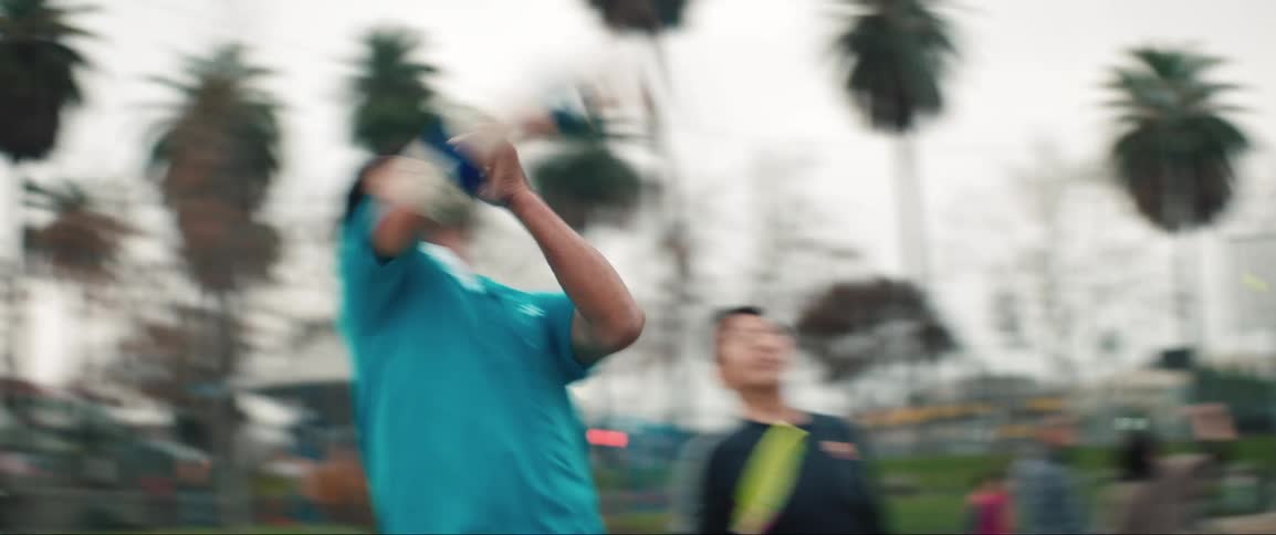 People are playing tennis in the park
