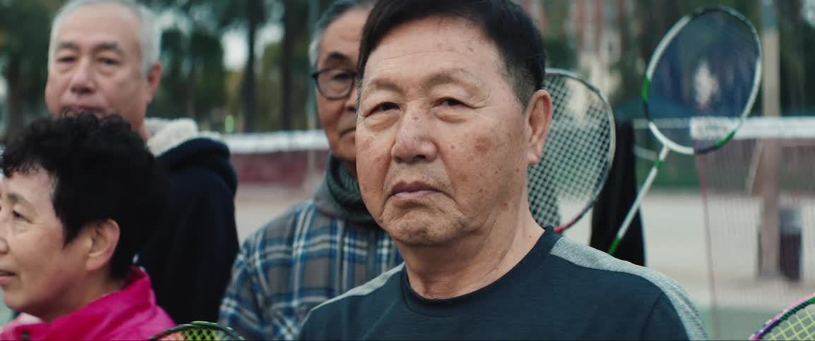 The people stand with their racquets