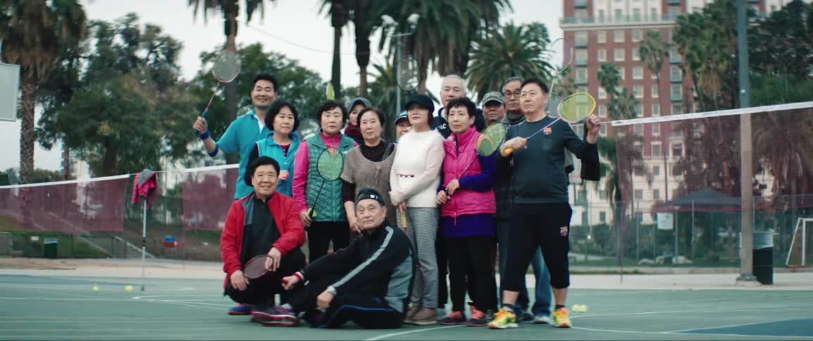 Group of badminton players posing together on court