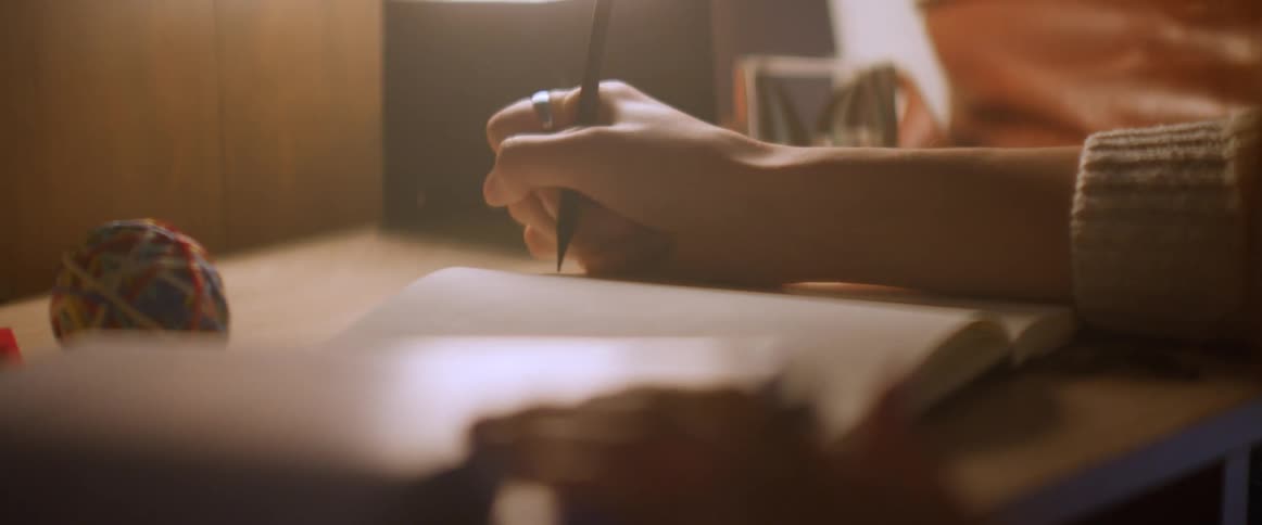 Woman sitting at the desk studies in her room