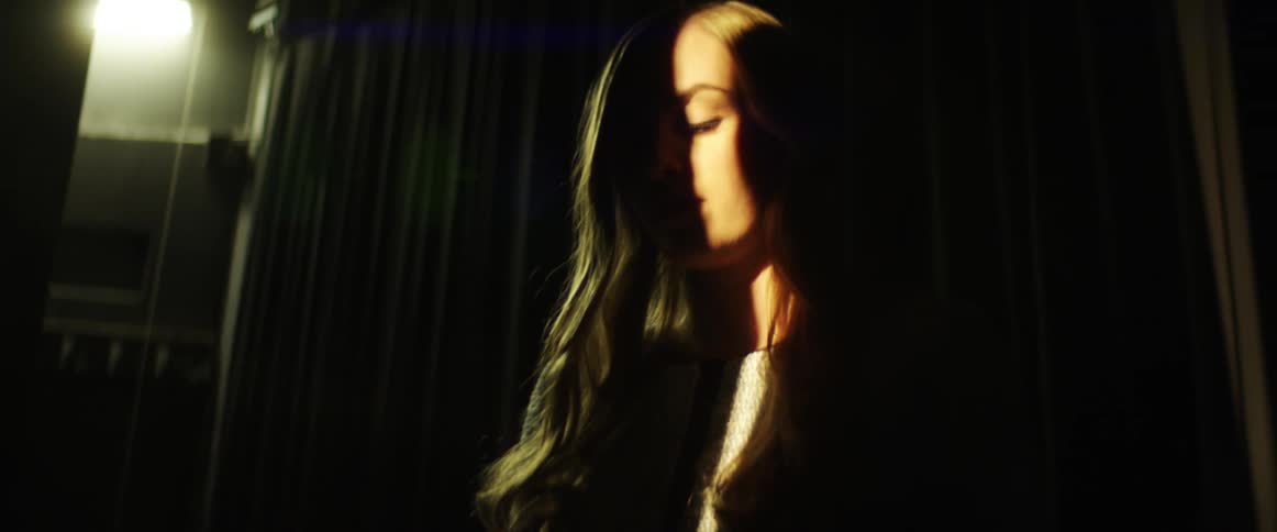 A woman checks her phone backstage