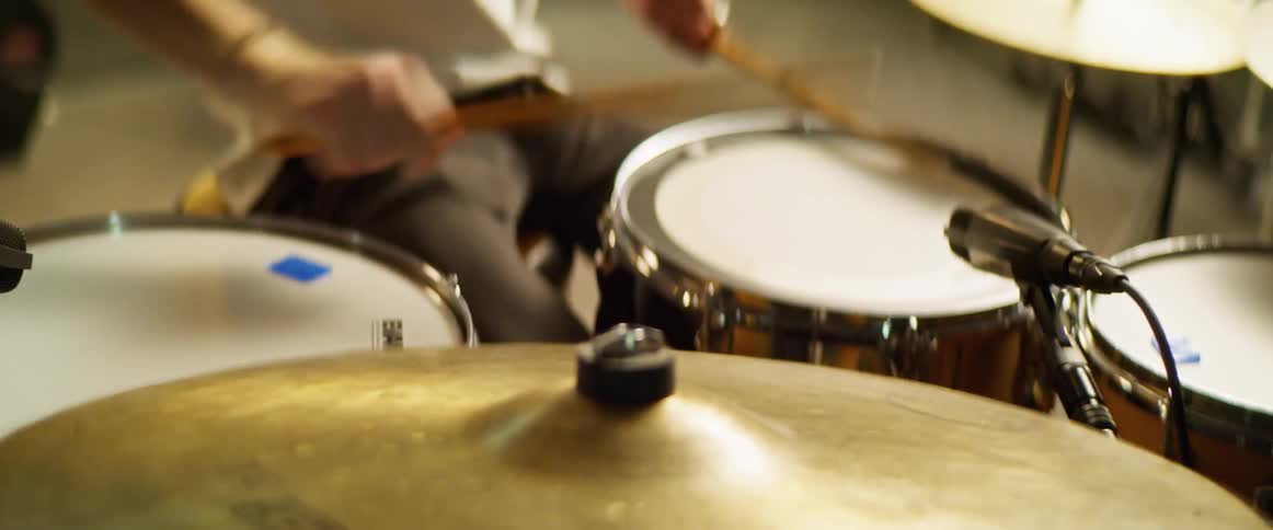 Drummer playing on drum kit