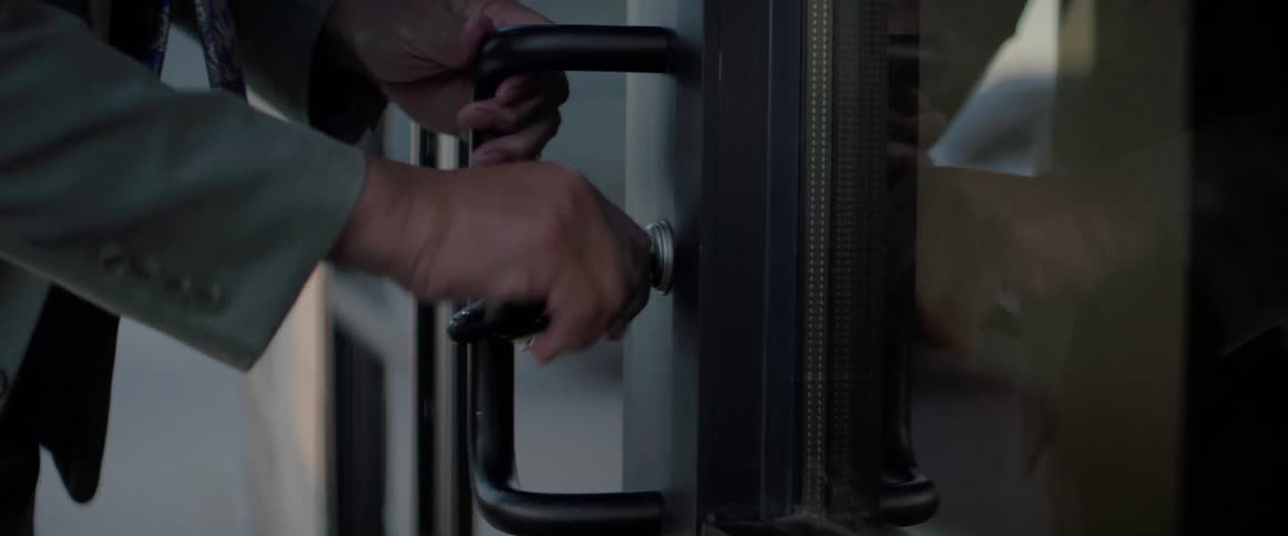 An employee is opening a door to enter a building