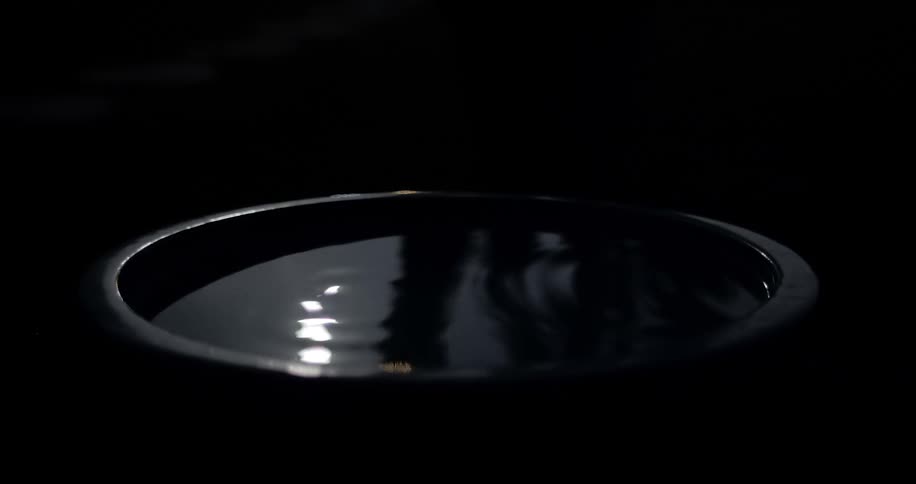 A bucket with water in it reflecting moonlight