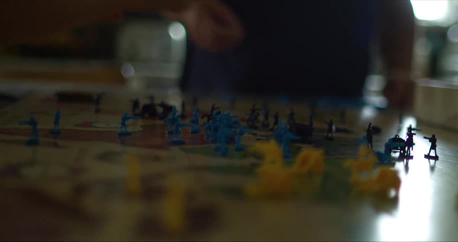 A man and woman play the game risk on the table at home