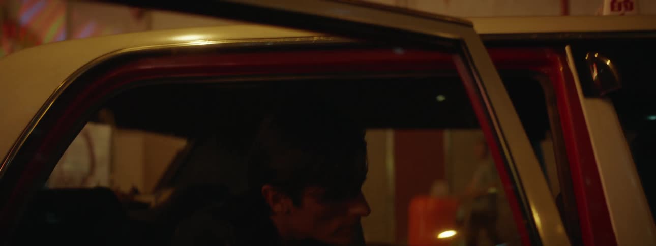 Man gets into a taxi at night