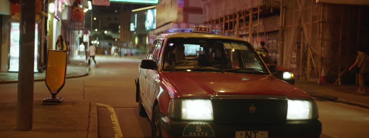 Card driving down a city street in an asian country