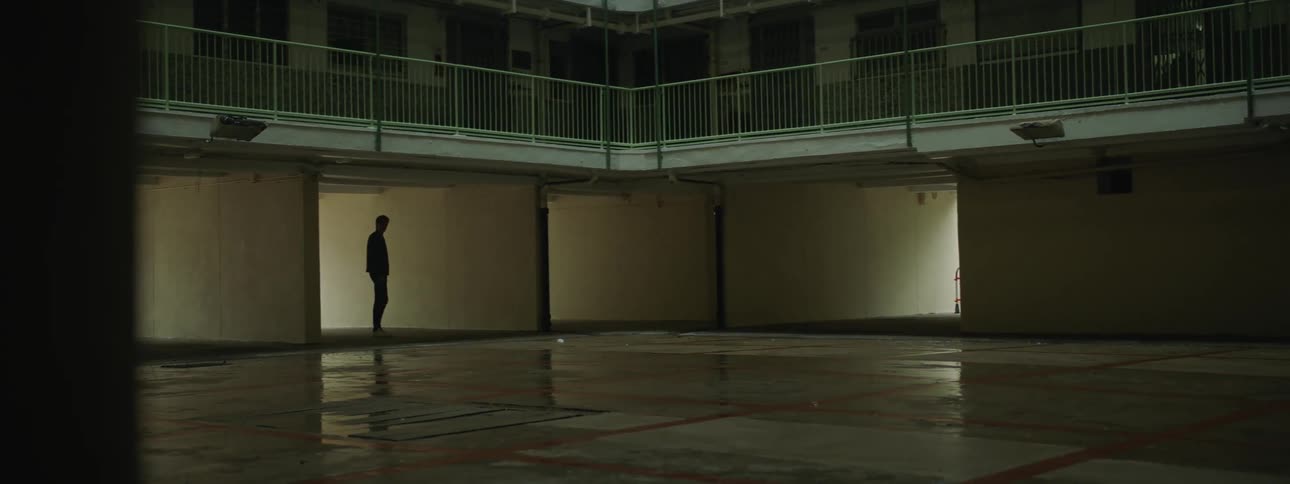 A man stands outside an motel