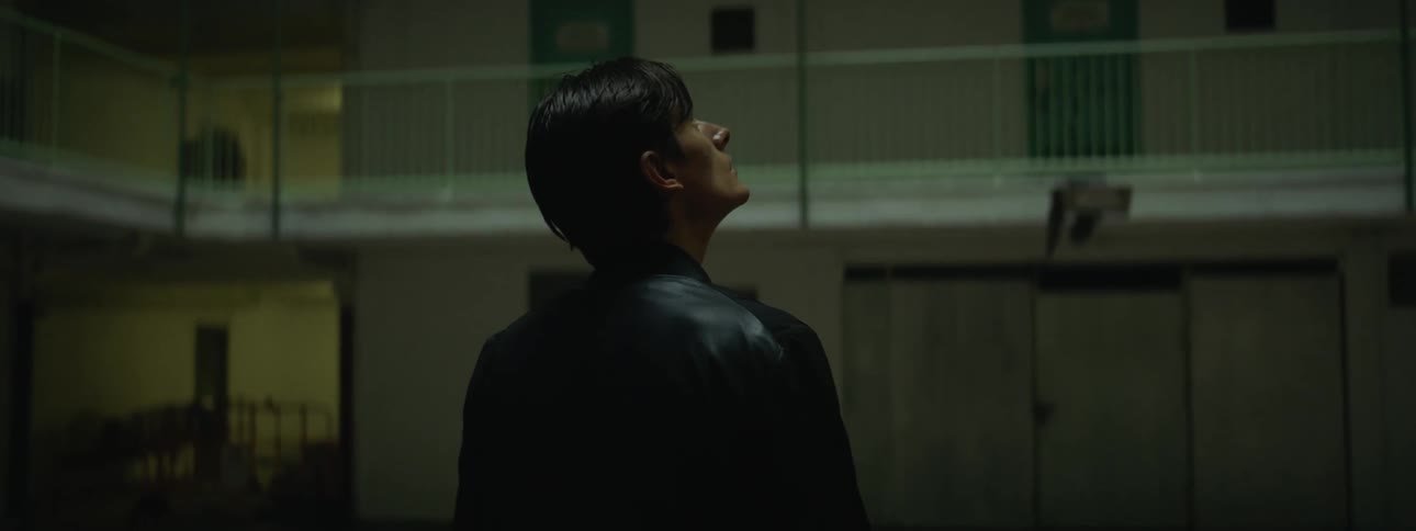 A man looks around the apartment buildings