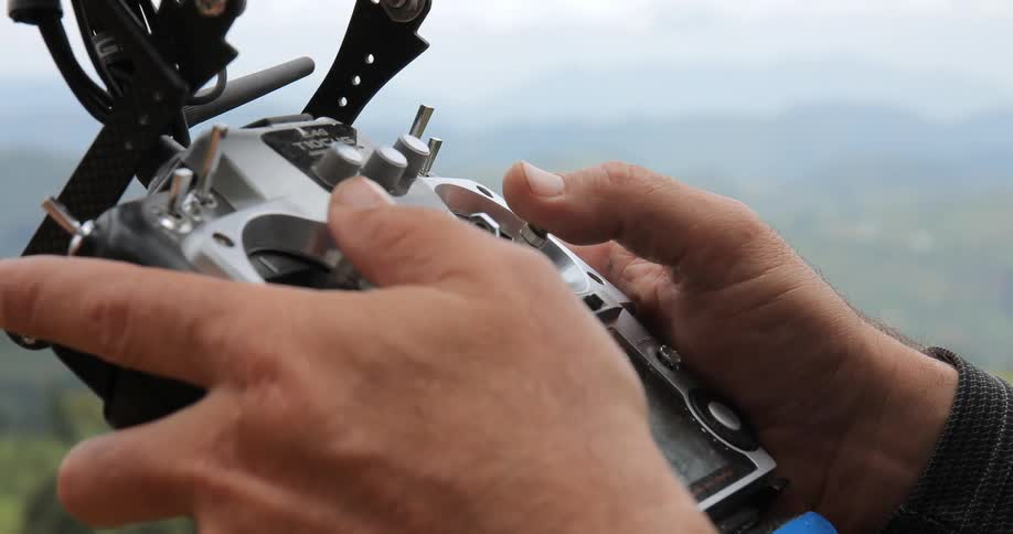 A man uses a controller outdoors