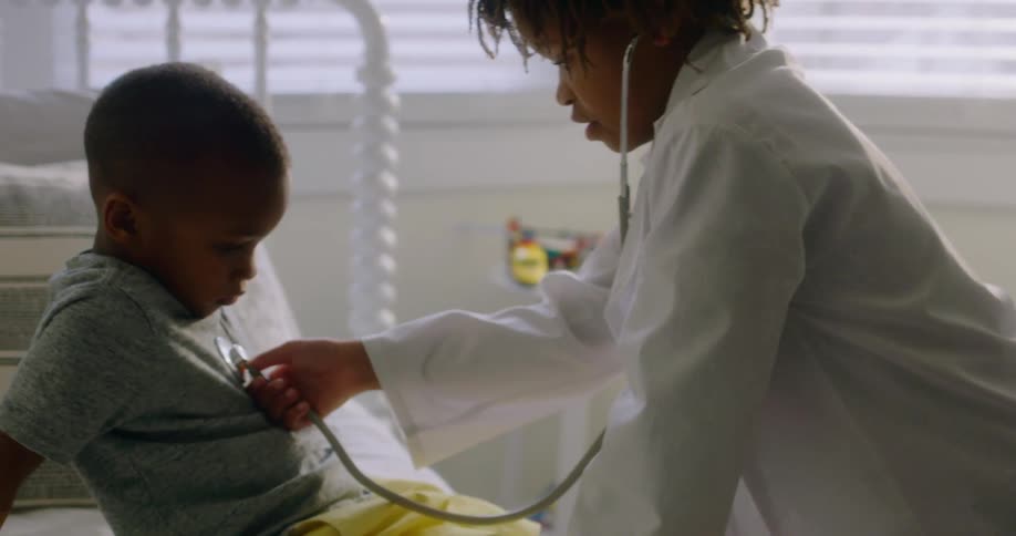 Big sister and little brother playing make believe doctor