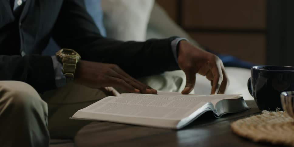 Man reading bible at coffee table