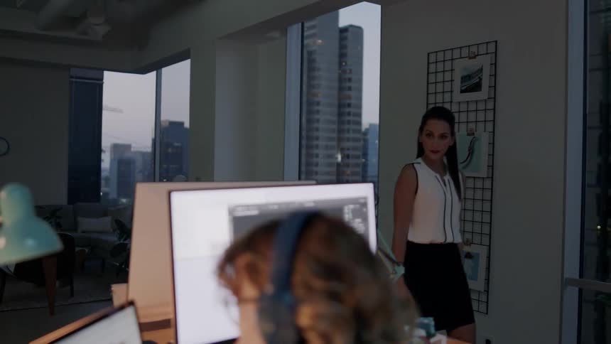 Women in urban office working late